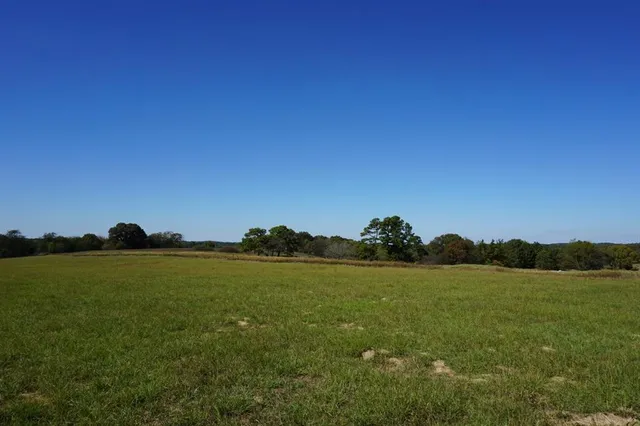 a large pool is sitting in the middle of a field