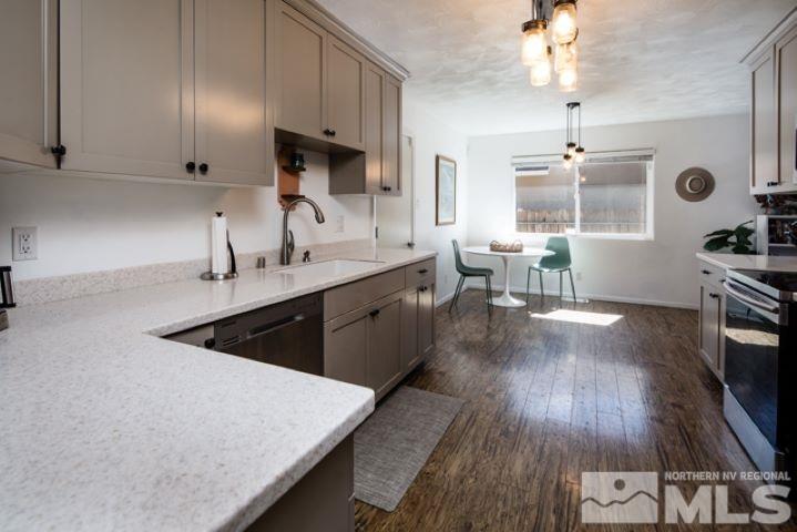 641 Beldon Way Reno, NV 89503 - Photo 5 of 21 a kitchen with a sink dishwasher a stove a microwave oven and a dining table with wooden floor