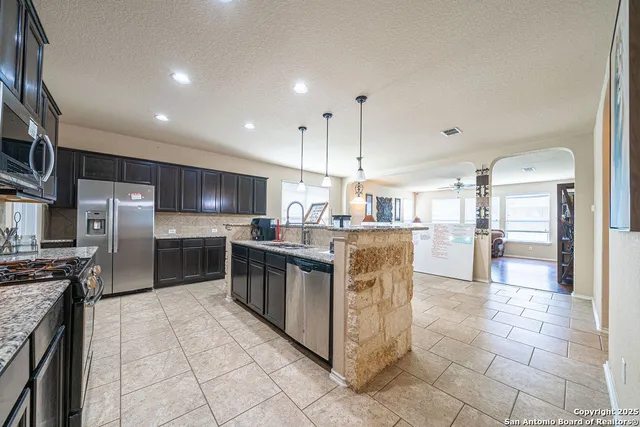 a kitchen with stainless steel appliances granite countertop a sink counter space cabinets and stainless steel appliances