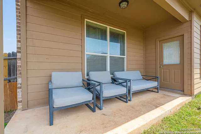 a view of a patio with a table and chairs