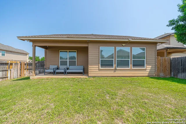 a view of a house with sitting area and garden