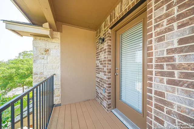 a view of a balcony with wooden floor and fence