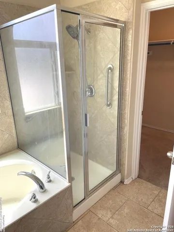 a bathroom with a tub and shower