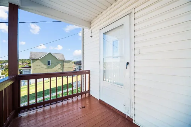 a view of hallway with wooden floor