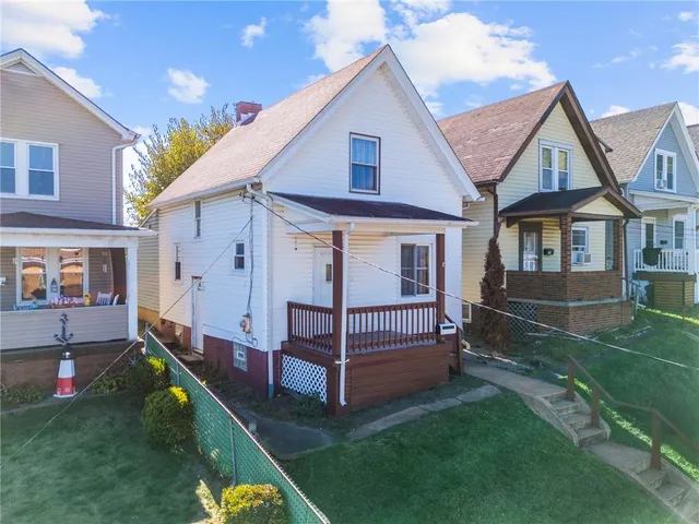 a house that has a tree in front of it