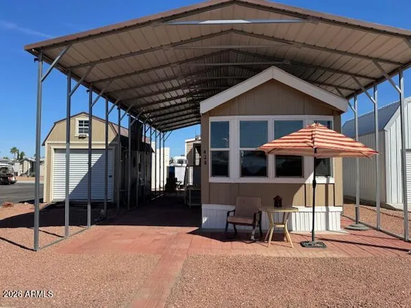 a view of a house with backyard porch and sitting area