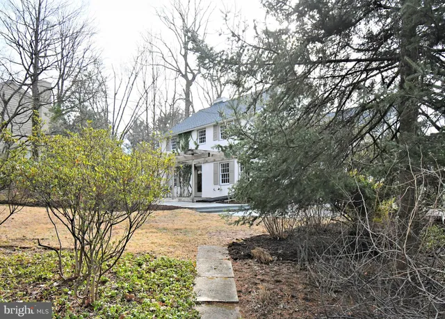 a front view of a house with a yard and trees