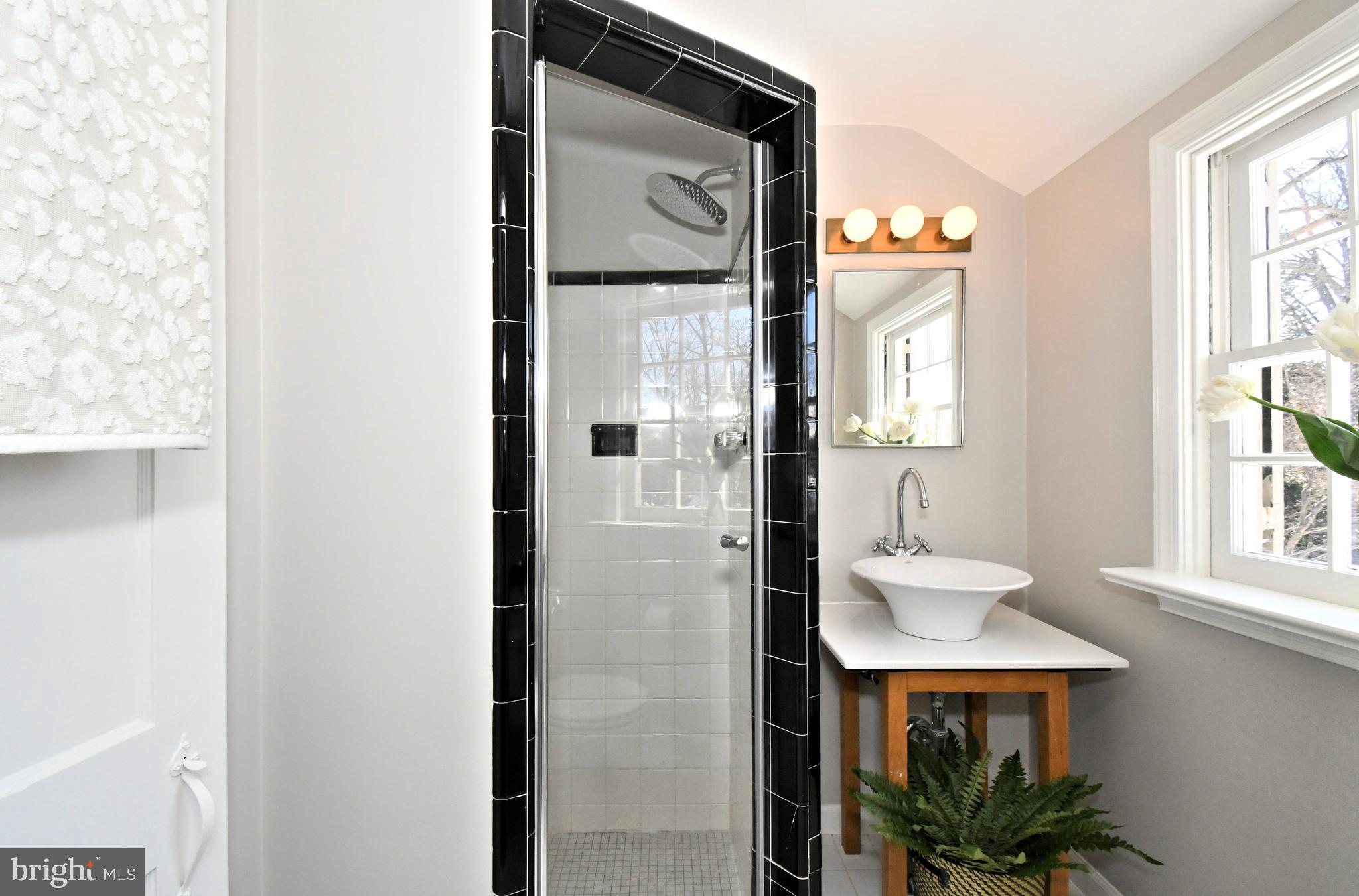 457 School House Lane Devon, PA 19333 - Photo 45 of 93 a bathroom with a sink a mirror and a window