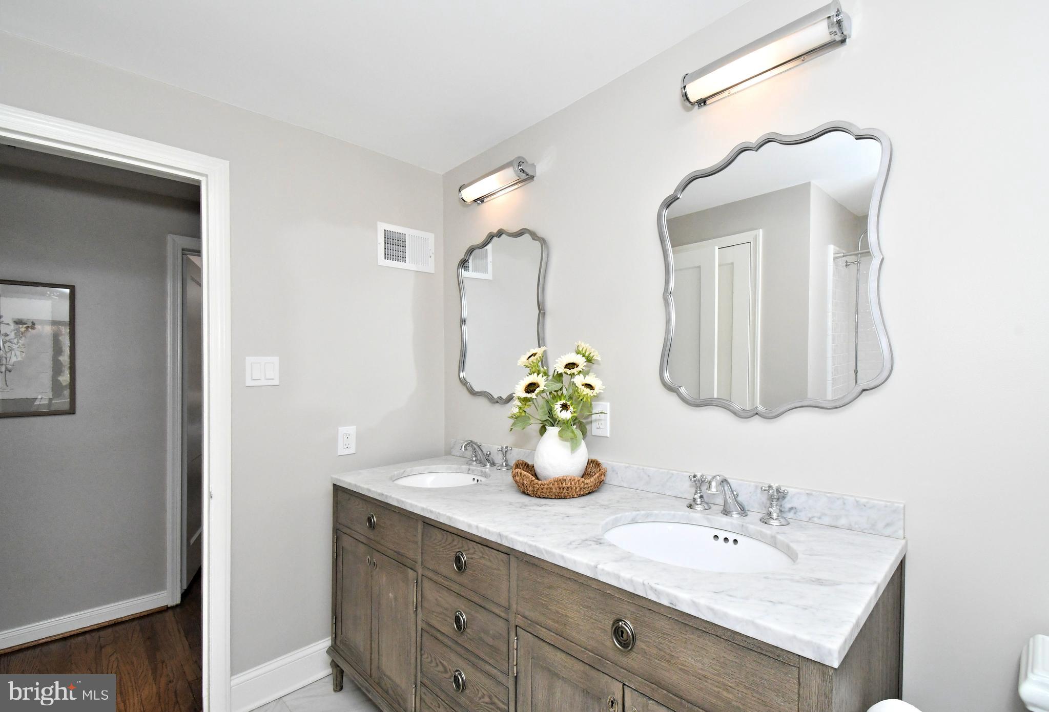 457 School House Lane Devon, PA 19333 - Photo 51 of 93 a bathroom with a sink vanity and a mirror