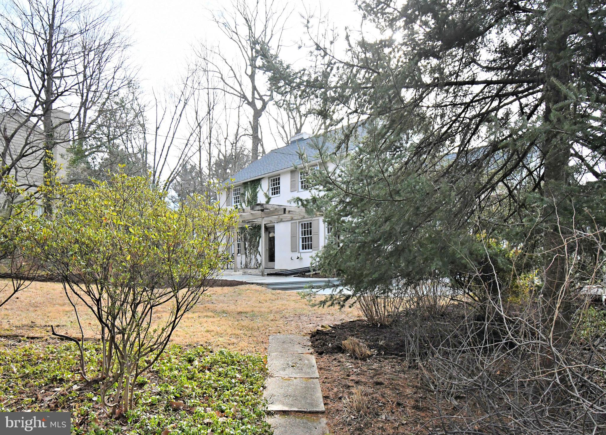 457 School House Lane Devon, PA 19333 - Photo 77 of 93 a front view of a house with a yard and trees