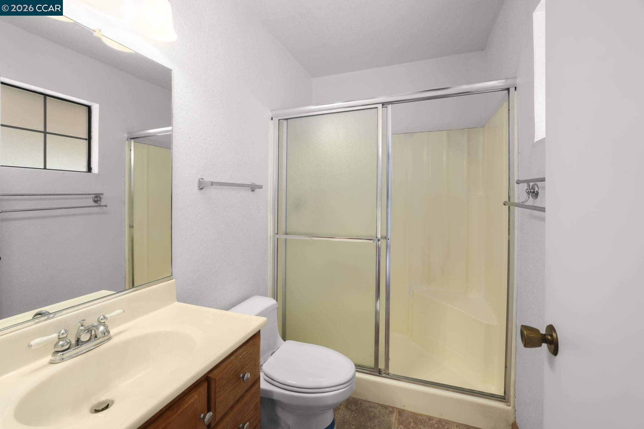 3438 Gregory Drive Bay Point, CA 94565 - Photo 16 of 24 a bathroom with a sink a toilet and shower