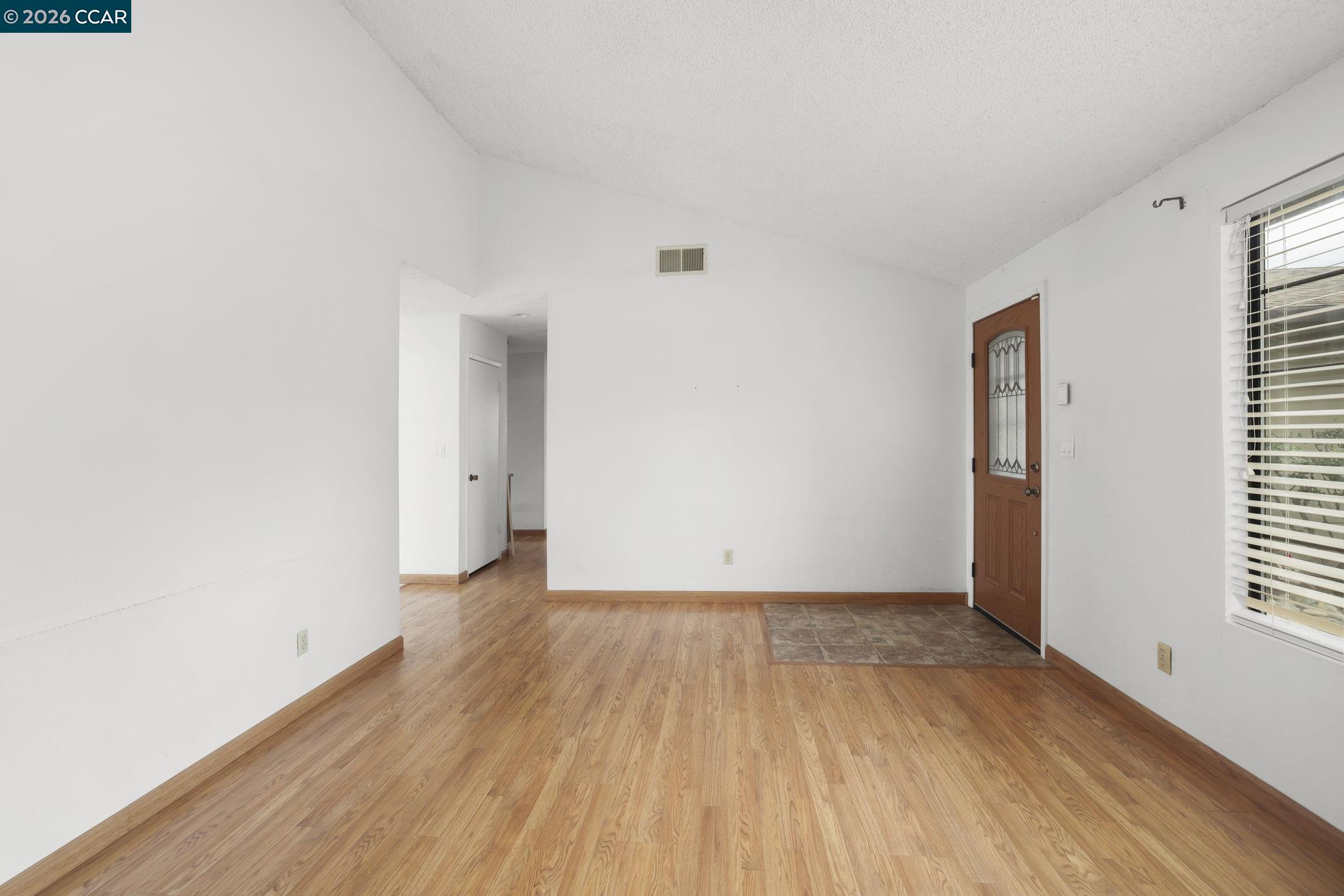 3438 Gregory Drive Bay Point, CA 94565 - Photo 7 of 24 an empty room with wooden floor and windows