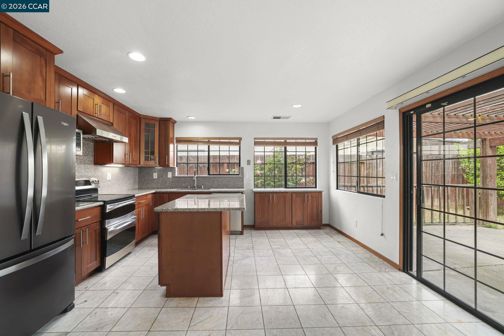 3438 Gregory Drive Bay Point, CA 94565 - Photo 9 of 24 a kitchen with stainless steel appliances granite countertop a refrigerator a sink a stove and a refrigerator