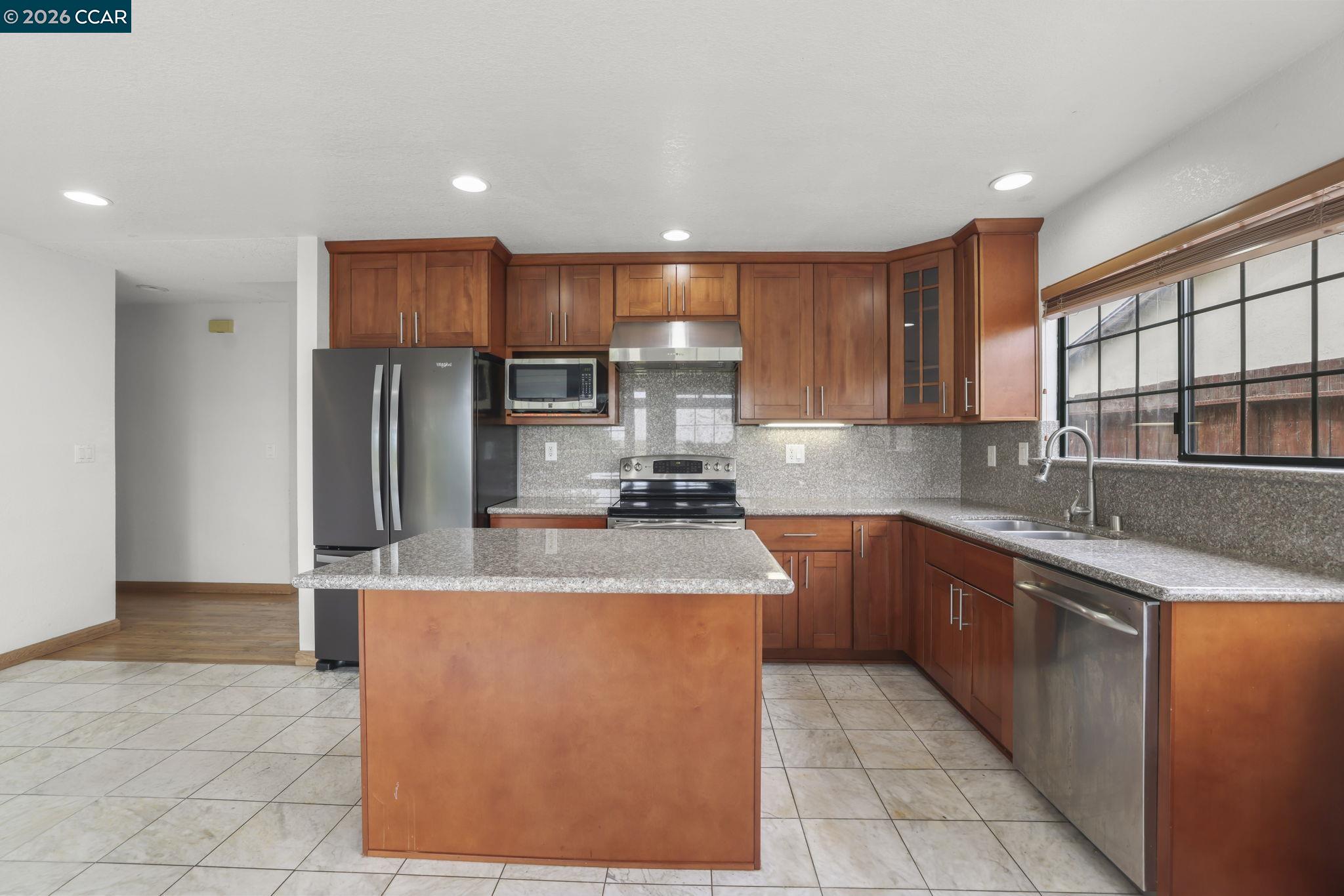 3438 Gregory Drive Bay Point, CA 94565 - Photo 10 of 24 a kitchen with stainless steel appliances granite countertop a sink refrigerator and cabinets