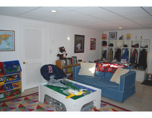 3 Marlboro Road Lexington, MA 02421 - Photo 16 of 18 a living room with furniture a flat screen tv and a bookshelf