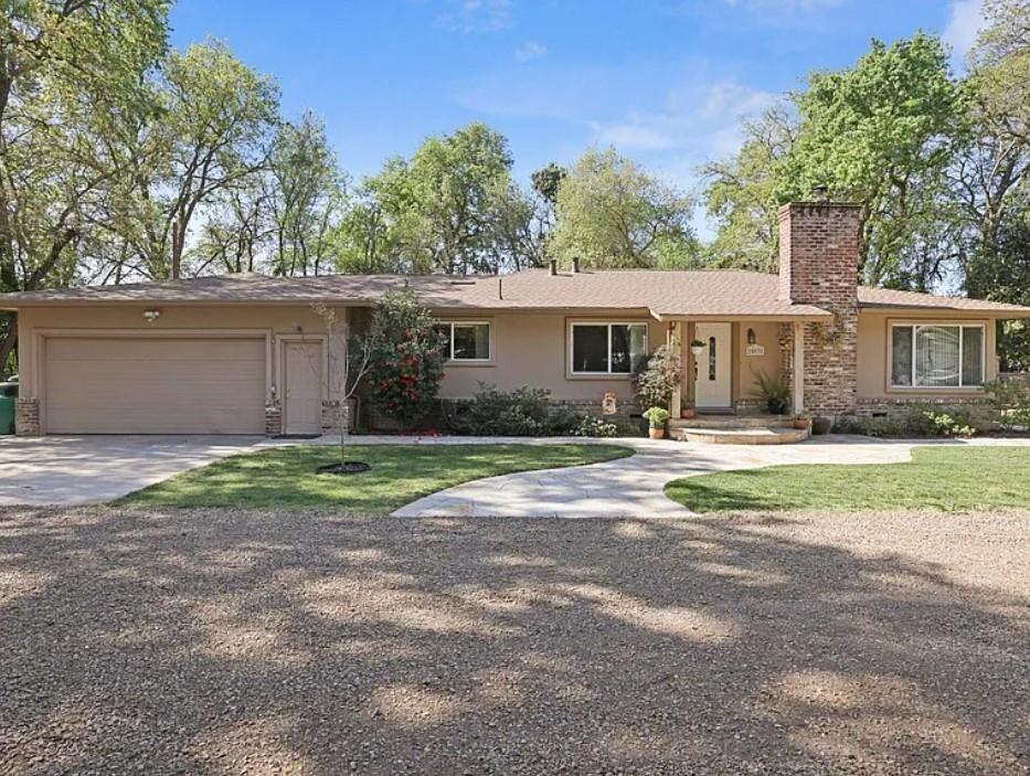 25931 Thornton Road Thornton, CA 95686 - Photo 1 of 31 a front view of a house with a yard and garage