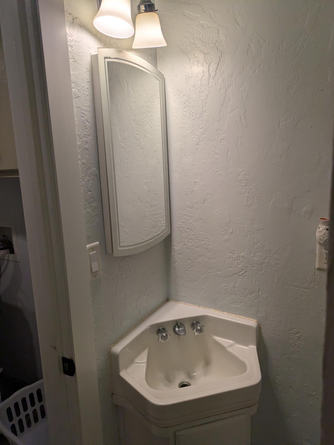 25931 Thornton Road Thornton, CA 95686 - Photo 13 of 31 a bathroom with a sink and mirror