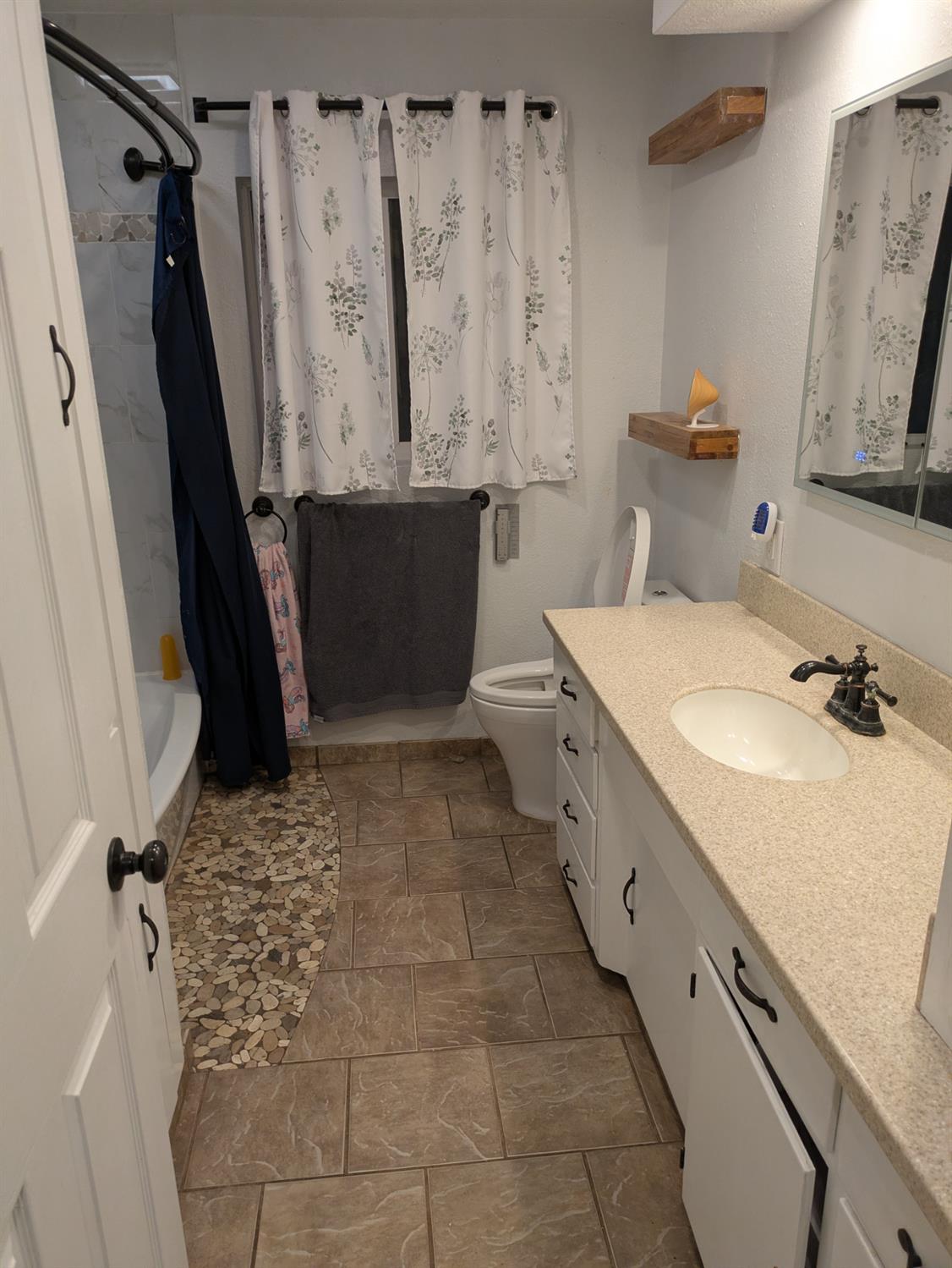 25931 Thornton Road Thornton, CA 95686 - Photo 17 of 31 a bathroom with a granite countertop sink toilet and shower
