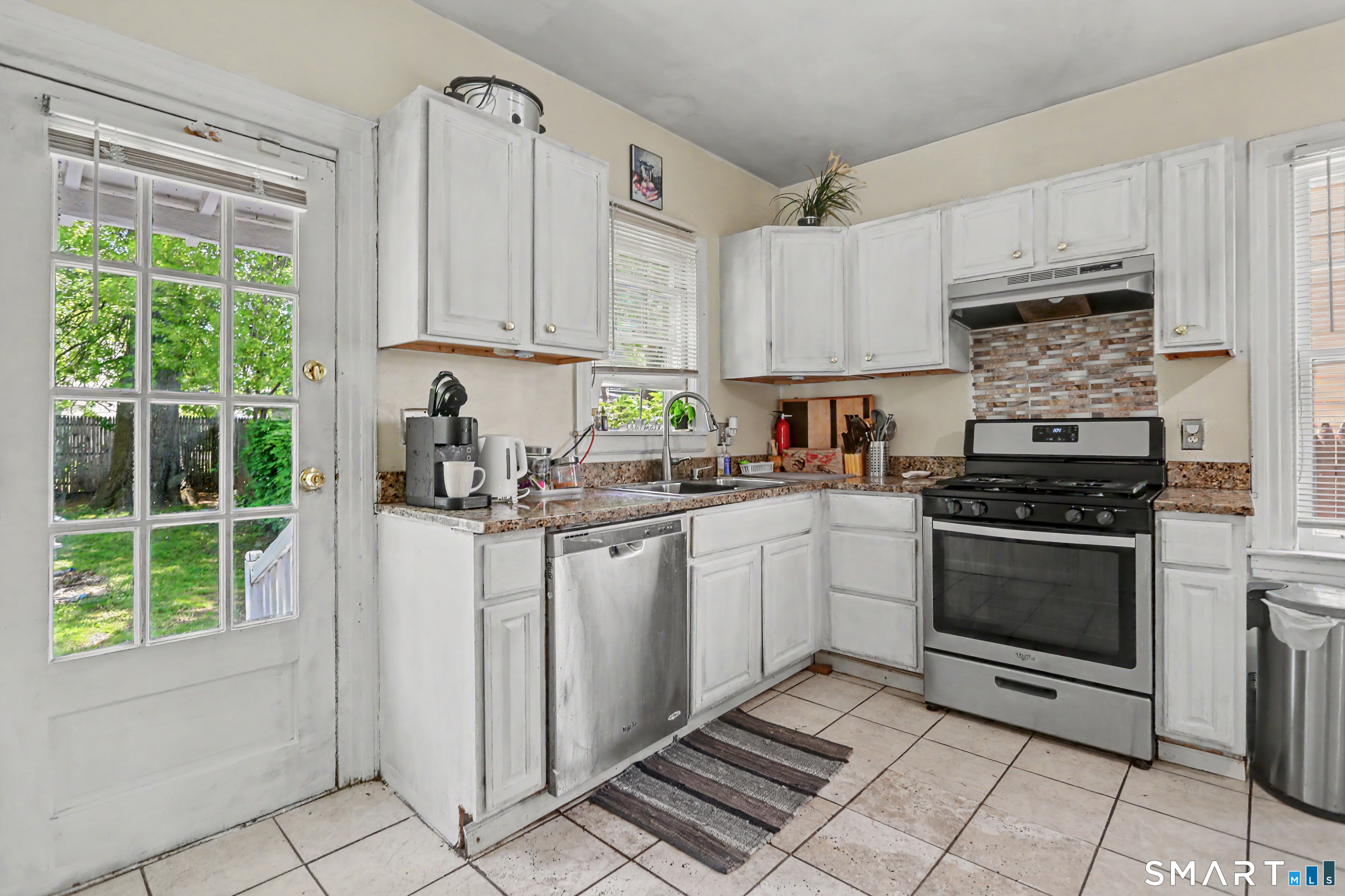 94 2nd Street Hamden, CT 06514 - Photo 13 of 31 a kitchen with stainless steel appliances granite countertop a stove a sink and a refrigerator