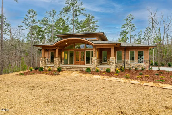 a front view of a house with a yard outdoor seating and garage