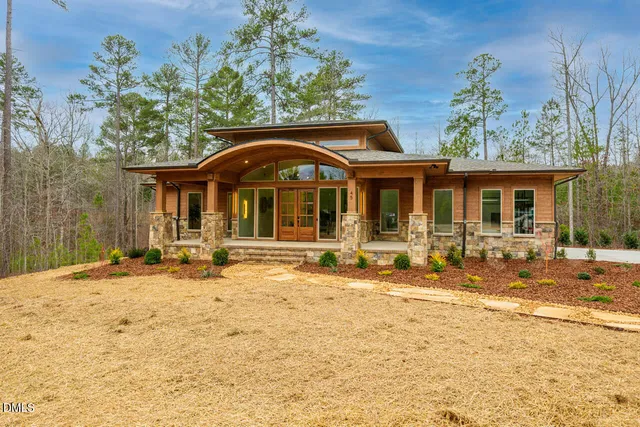 a front view of a house with a yard outdoor seating and garage