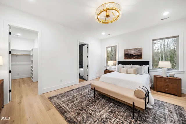 a view of a swimming pool with a table and chairs under an umbrella