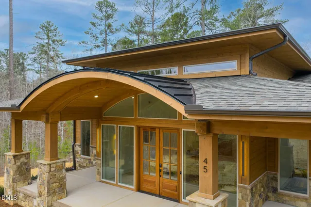 an aerial view of a house with large trees