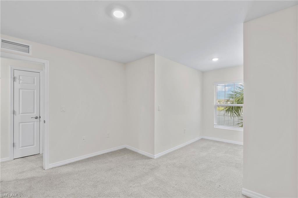 15535 Wildflower Circle Naples, FL 34119 - Photo 21 of 33 an empty room with windows