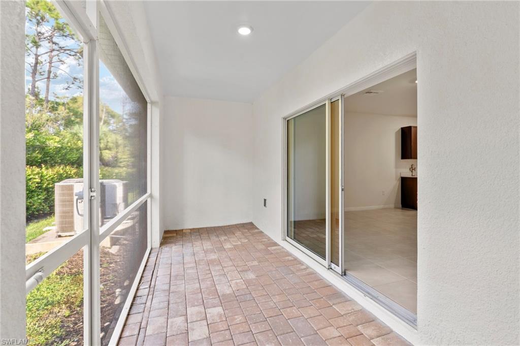 15535 Wildflower Circle Naples, FL 34119 - Photo 25 of 33 a view of a hallway with windows