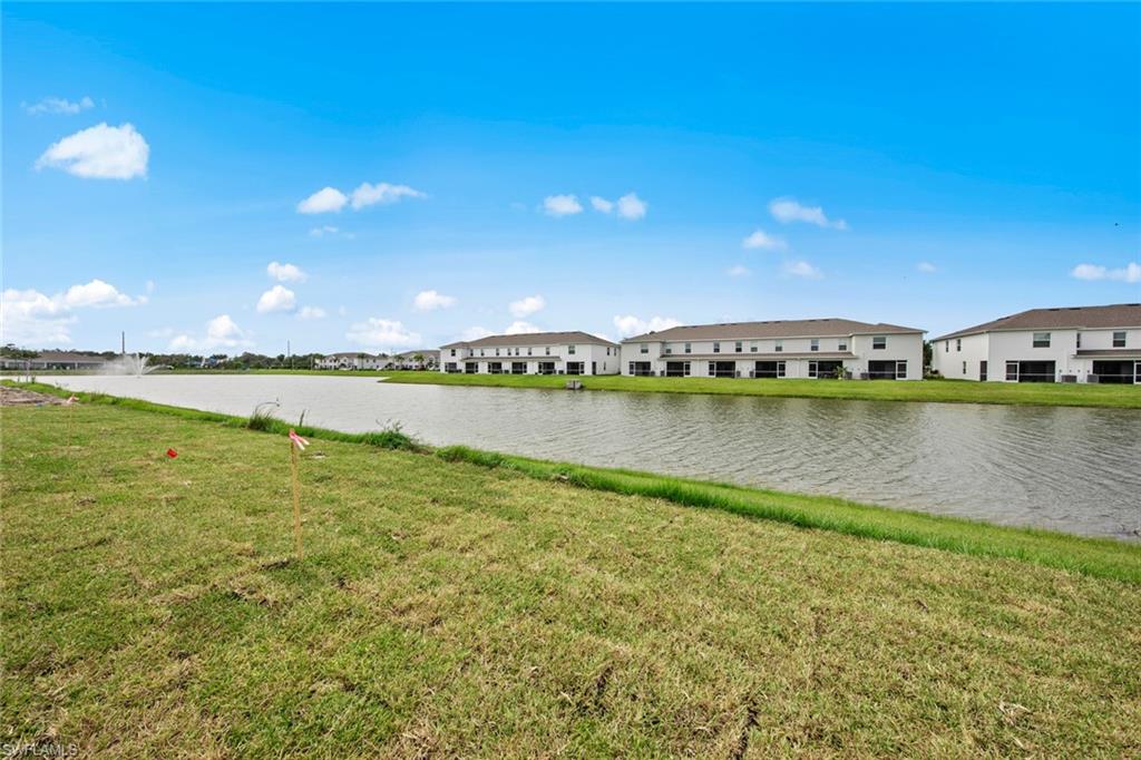 15535 Wildflower Circle Naples, FL 34119 - Photo 32 of 33 a view of a lake with houses in the back