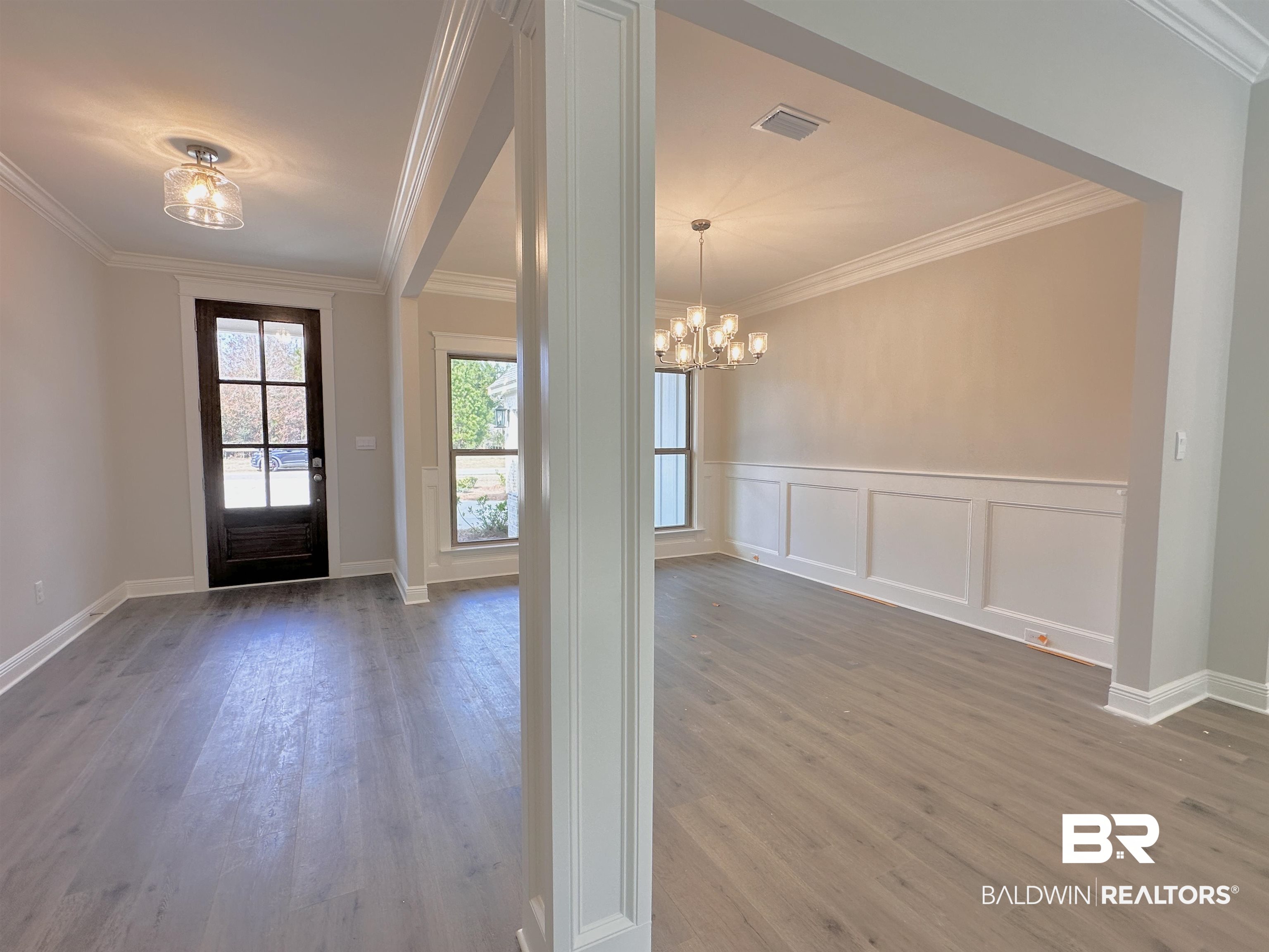 630 Kitfox Avenue Fairhope, AL 36532 - Photo 3 of 40 Foyer with hardwood / wood-style flooring, crown molding, and a notable chandelier