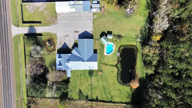 an aerial view of a house with a swimming pool
