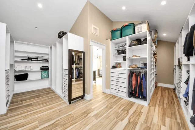a view of a walk in closet and kitchen