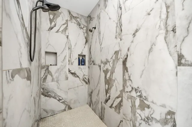 a bathroom with a bathtub and shower