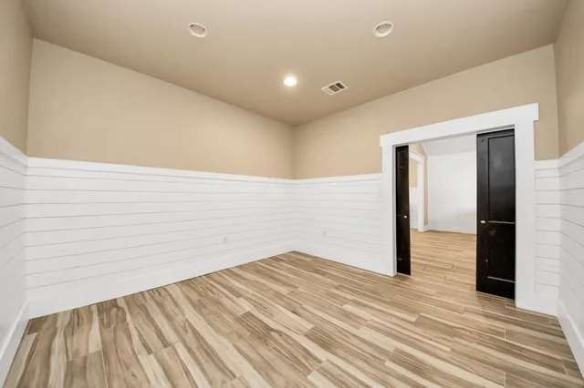 a view of a room with wooden floor