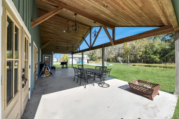 a large kitchen with a stove a sink dishwasher and wooden cabinets with wooden floor