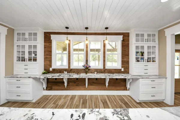 a large kitchen with stainless steel appliances granite countertop a lot of counter space and a sink