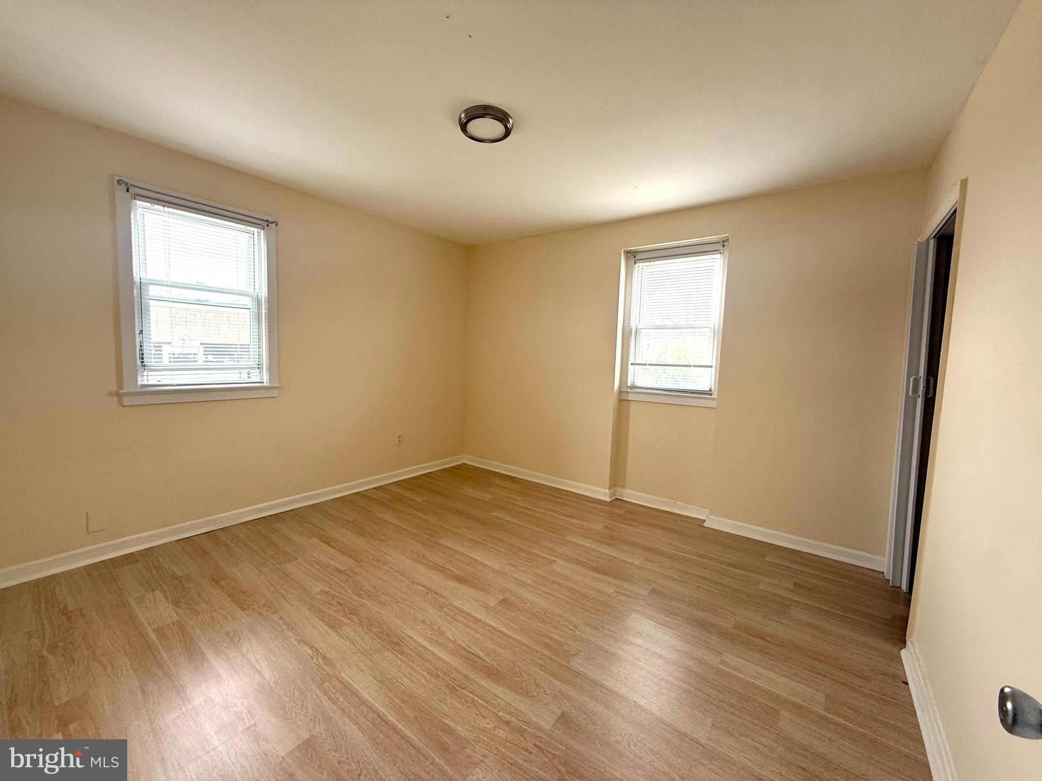 2852 Iverson Street, Unit 110 Temple Hills, MD 20748 - Photo 15 of 23 an empty room with wooden floor and windows