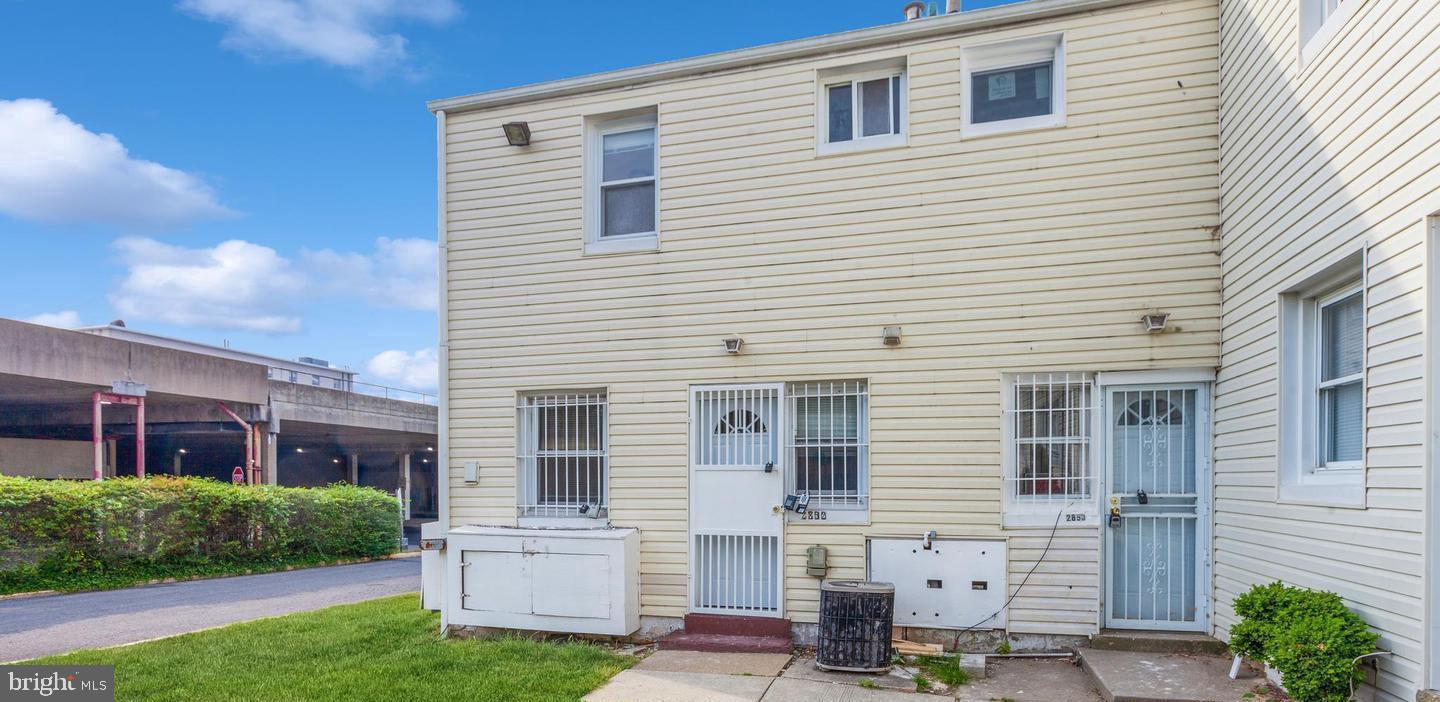 2852 Iverson Street, Unit 110 Temple Hills, MD 20748 - Photo 2 of 23 a front view of a house with a yard