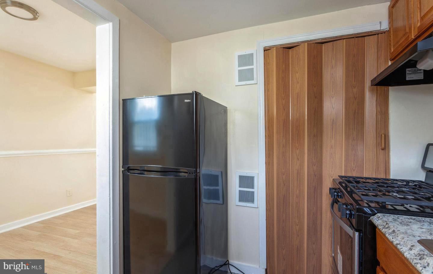 2852 Iverson Street, Unit 110 Temple Hills, MD 20748 - Photo 4 of 23 a kitchen with a refrigerator and a stove top oven