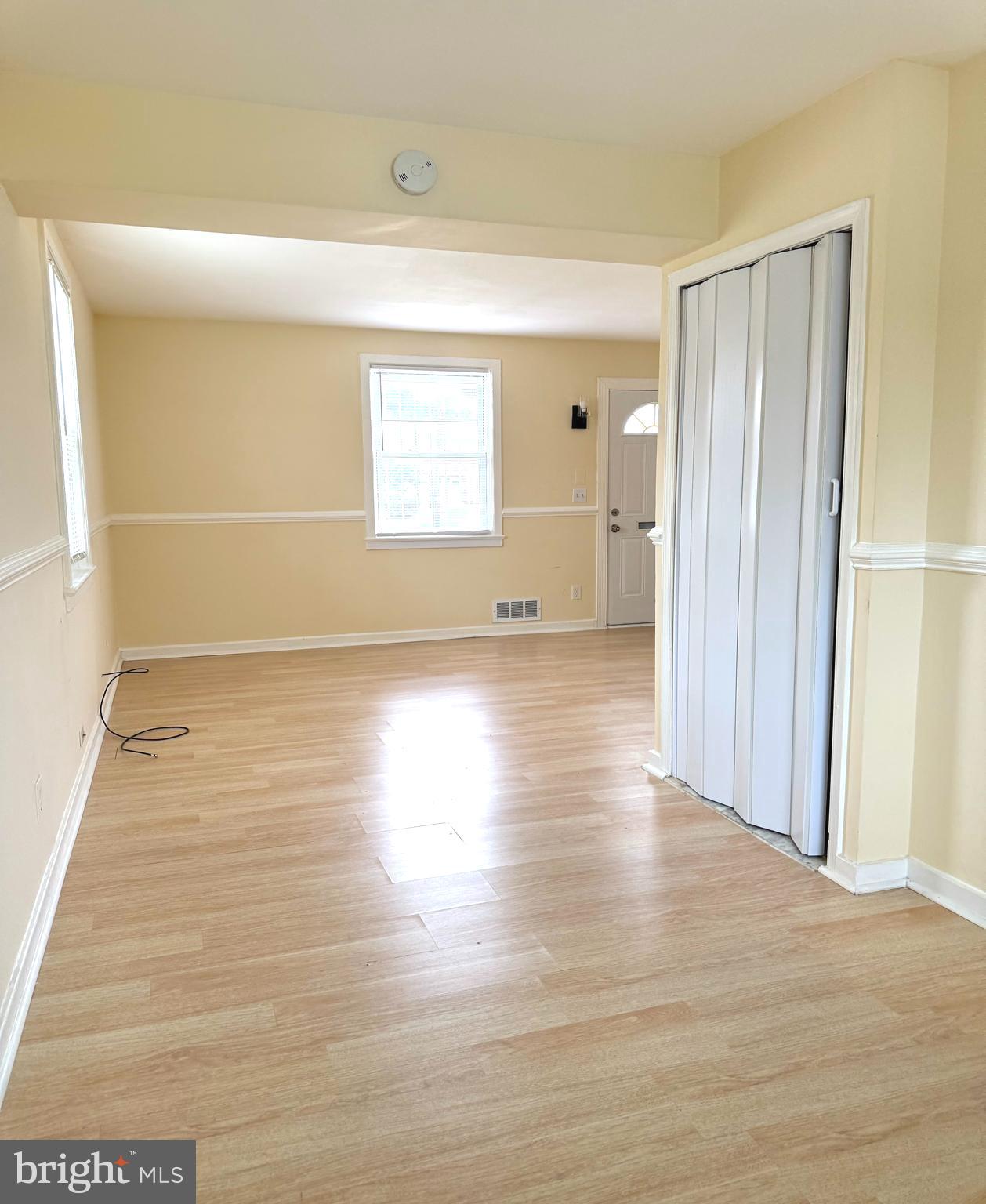 2852 Iverson Street, Unit 110 Temple Hills, MD 20748 - Photo 5 of 23 a view of a room with wooden floor and a window