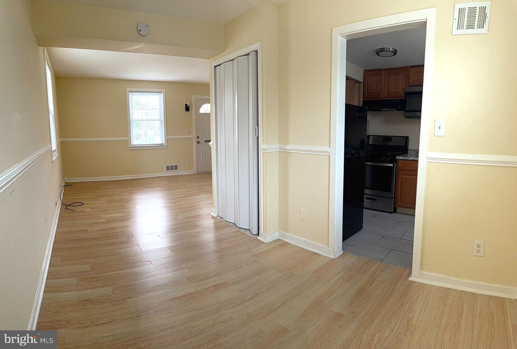 2852 Iverson Street, Unit 110 Temple Hills, MD 20748 - Photo 6 of 23 a view of a hallway with wooden floor and closet area