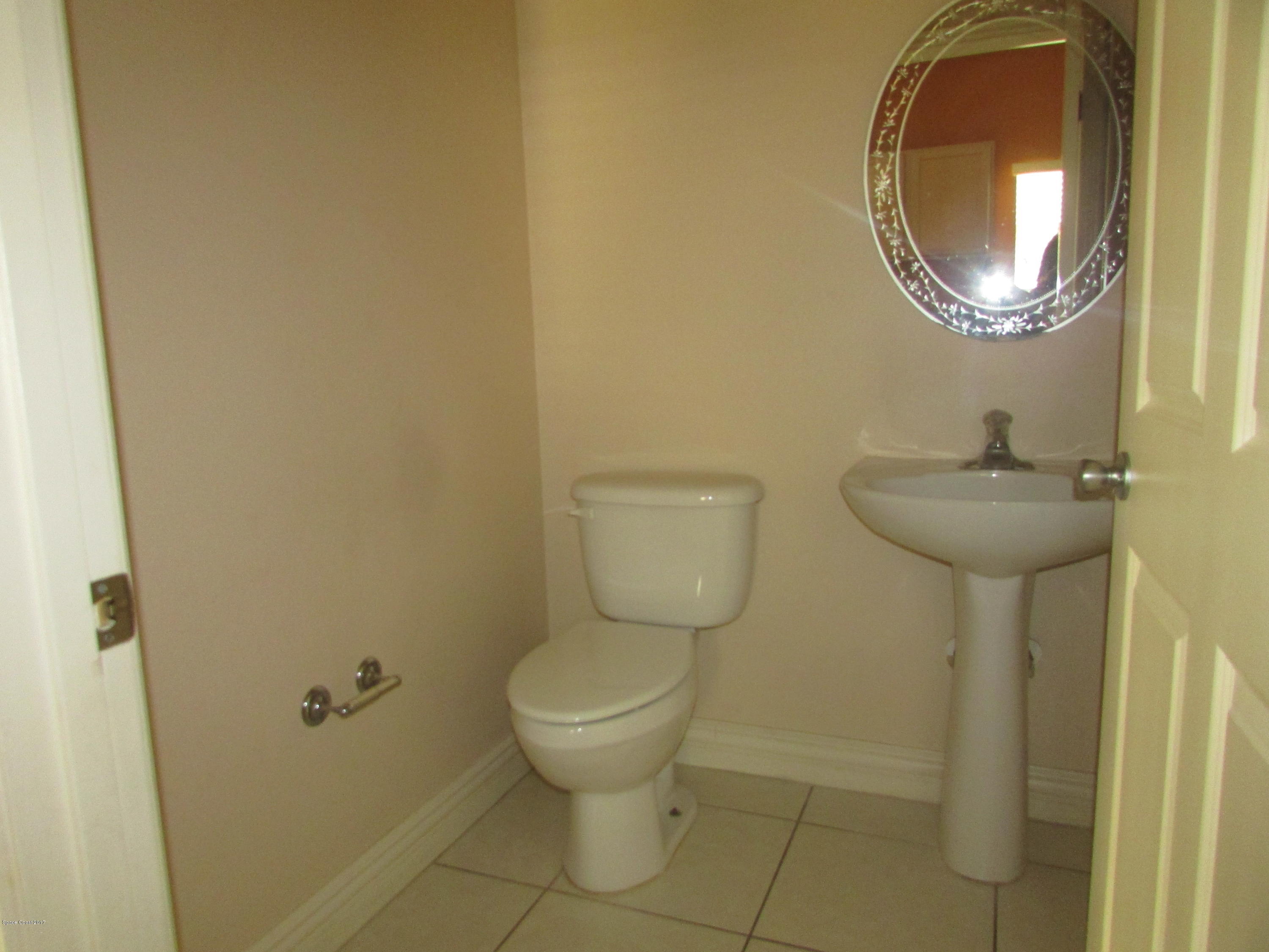629 Cedar Side Circle Northeast Palm Bay, FL 32905 - Photo 7 of 12 1/2 bath off Kitchen