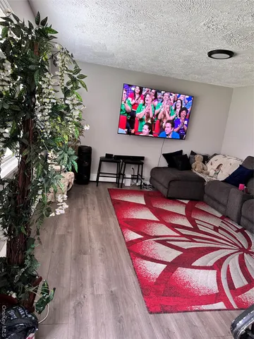 a living room with furniture a flowers and a rug