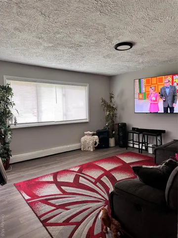 a bedroom with furniture and a flat screen tv