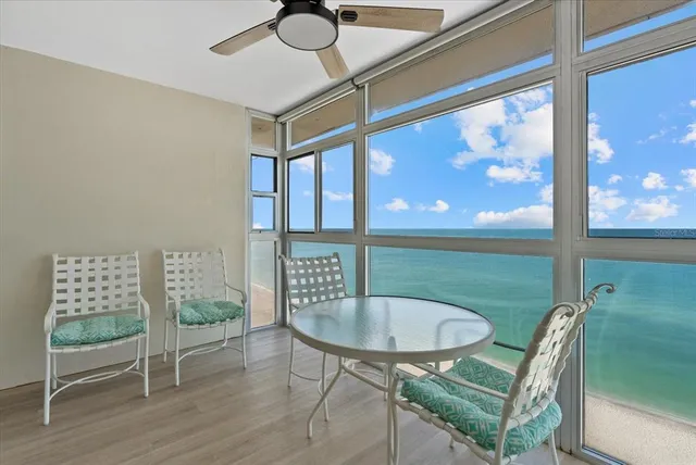 a view of a room with a table and chairs