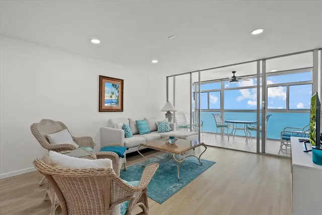 a living room with furniture and a floor to ceiling window