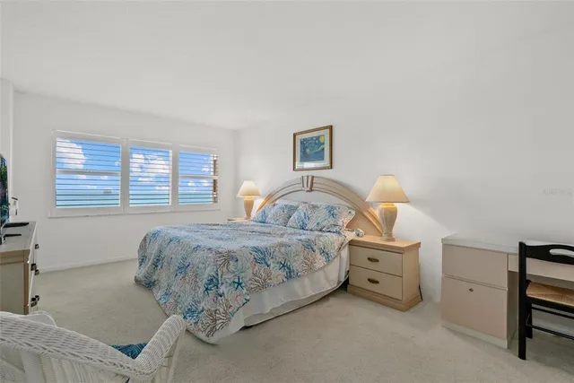 a bed room with a bed and a lamp