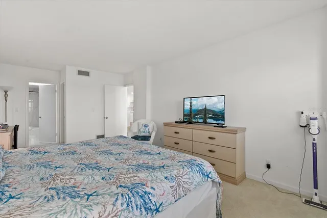 a bedroom with a bed and a dresser