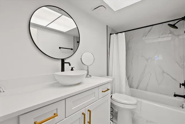 a bathroom with a sink a mirror and a toilet